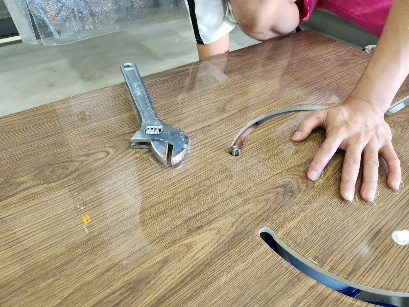Person cutting sintered stone slab with diamond blade saw
