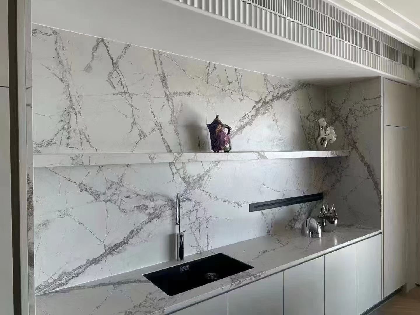 white sintered stone backsplash